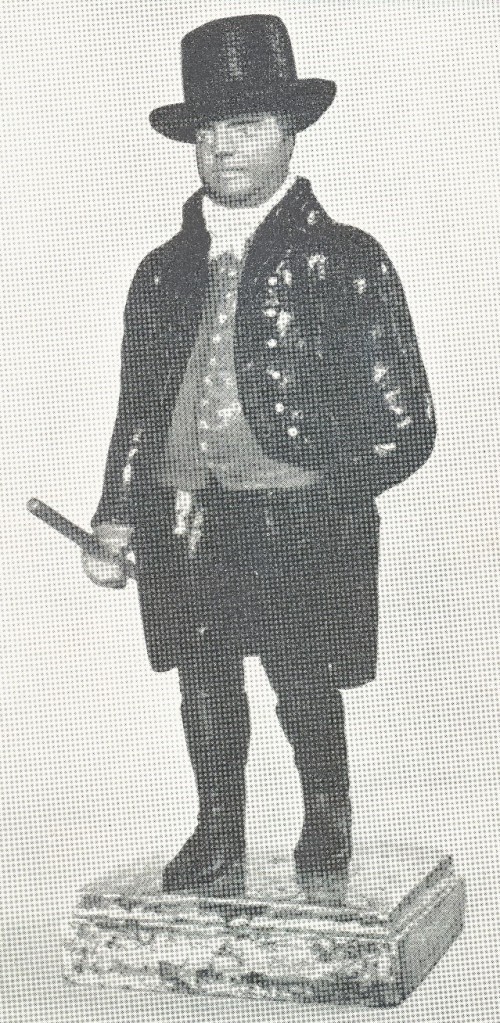 A figurine showing John Townsend with his tipstaff – badge of office